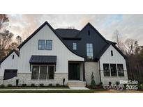 Stunning new construction home with a modern farmhouse exterior and stone accents at 136 Castleview Ln, Mooresville, NC 28115