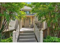 Inviting front porch of home with chairs, railing, plants and a wreath on the front door at 14118 Yachtsman Harbor Dr, Charlotte, NC 28278