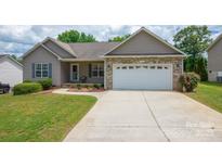 Quaint home featuring well-kept landscaping, and an attached two-car garage at 206 Pine Meadow St, Hickory, NC 28601