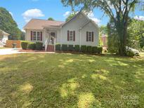 Charming single-story home with well-manicured lawn, tidy shrubbery and brick steps leading to a cozy front porch at 211 Sherwood Cir, Rock Hill, SC 29730