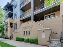 Stylish condo building with multi-story balconies, brick facade and well-maintained landscaping at 2401 Euclid Ave # 207, Charlotte, NC 28203