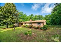 Charming brick home featuring well-maintained landscaping and a lush green lawn at 2871 Loviee Rd, Lincolnton, NC 28092