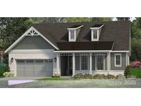 Charming single-story home with a gray brick facade, attached two-car garage and a covered front porch at 4444 Moxie Way, Charlotte, NC 28215