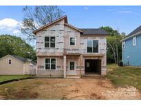Unfinished two-story home featuring a modern architectural design and an attached garage at 522 Herms Ave, Mount Holly, NC 28120
