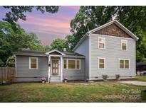 Charming home featuring a well-maintained lawn, gray siding, and a welcoming front entrance at 5421 Princess St, Charlotte, NC 28269