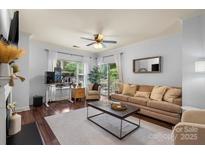 Inviting living room featuring a comfortable sofa, stylish coffee table and large windows for natural light at 5730 Closeburn Rd # H, Charlotte, NC 28210
