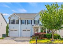 Charming two-story home with a well-manicured lawn, two-car garage, and inviting curb appeal at 6424 Chadwell Ct, Fort Mill, SC 29707
