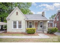 Charming one story home featuring a brick facade, covered porch, and well-maintained landscaping at 813 S Ridge Ave, Kannapolis, NC 28083