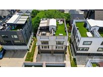 Aerial view of a modern townhouse with a rooftop deck featuring seating and artificial turf at 945 Westbrook Dr # A, Charlotte, NC 28202
