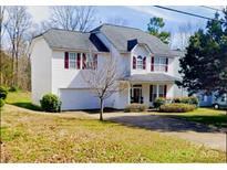 Charming two-story home with a well-maintained lawn and cozy curb appeal at 10016 Lawing School Rd, Charlotte, NC 28214
