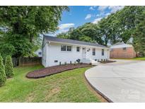Charming renovated ranch home with freshly painted exterior and well manicured landscaping at 1218 E Woodlawn Rd, Charlotte, NC 28209