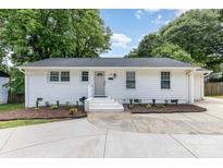 Charming single-story home featuring a freshly painted exterior, tidy landscaping and a newly updated driveway at 1218 E Woodlawn Rd, Charlotte, NC 28209