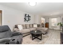 Comfortable living room showcasing a plush sectional sofa, accent chair, and neutral color palette at 1218 E Woodlawn Rd, Charlotte, NC 28209