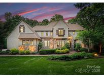 Charming stone and wood home featuring mature landscaping and beautiful architectural details at 12835 Ninebark Trl, Charlotte, NC 28278