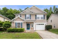 Charming two-story home with blue shutters, attached garage, manicured landscaping, and an inviting front entrance at 14010 Pinyon Pine Ln, Charlotte, NC 28215