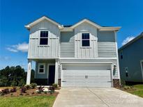 Charming two-story home with a two-car garage, gray siding, and neatly landscaped front yard at 1420 Wildflower St, Newton, NC 28658