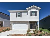 Charming two-story home with a brick and white siding exterior and a two-car garage at 1420 Wildflower St, Newton, NC 28658