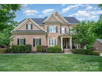 Charming two-story brick home with a well-manicured lawn and beautiful landscaping at 16109 Reynolds Dr, Indian Land, SC 29707