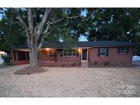 Charming brick home featuring well-maintained landscaping and a cozy front porch, offering great curb appeal at 1900 Walkup Ave # 1, Monroe, NC 28110