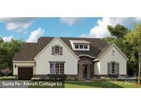 Inviting Santa Fe-French cottage featuring a stone-accented entrance, attached garage, and manicured lawn at 19329 Youngblood W Rd # 4, Charlotte, NC 28278