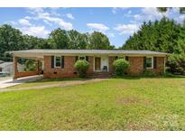 Charming brick ranch home featuring a covered carport and a well-maintained lawn at 2718 Ridgewood Ln, Rock Hill, SC 29730