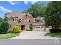 Charming brick home with a three-car garage and a spacious driveway at 3815 Stoney Ridge Trl, Charlotte, NC 28210