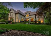 Elegant home with a lush, green lawn and meticulously manicured landscaping at 405 Gladelynn Way, Waxhaw, NC 28173