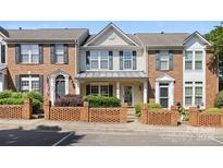 Charming townhome with brick facade, manicured landscaping, and inviting front porch at 4100 B Christine Ln, Waxhaw, NC 28173