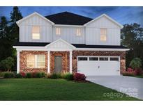 Beautiful two-story home with brick and white siding, a two-car garage, and well-maintained landscaping at 426 Bent Burr Crk, York, SC 29745