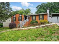 Charming brick home with a well-manicured lawn and inviting stairway entrance at 6221 Thermal Rd, Charlotte, NC 28211