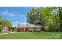 Charming single-story home featuring a well-maintained lawn and beautiful landscaping at 8206 Idlewild Rd # 22, Indian Trail, NC 28079