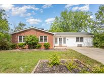 Charming single-story home featuring a brick facade, white siding, and a well-manicured front yard at 830 Cabaniss Dr, Shelby, NC 28150