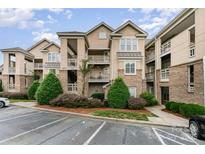 Well-maintained condo building with manicured landscaping and ample parking at 104 Pier 33 Dr # 311, Mooresville, NC 28117