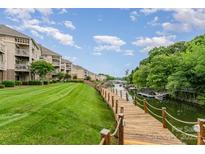 Beautiful waterfront condo community with a wooden boardwalk and meticulously maintained lawns at 104 Pier 33 Dr # 311, Mooresville, NC 28117