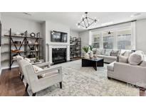 Bright living room featuring a fireplace, modern lighting, and comfortable seating arrangement at 1102 Sugar Creek Rd, Indian Land, SC 29707