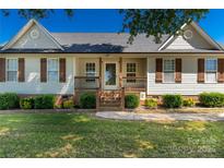 Charming single story home with covered front porch and meticulously maintained landscaping at 1560 Springlake Rd, York, SC 29745