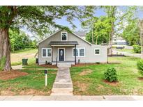 Charming bungalow-style home with a well-manicured lawn and inviting front porch at 225 N Lee St, Mount Holly, NC 28120