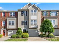 Charming townhome featuring a well-maintained lawn and a private attached garage at 245 Rock Ridge Ln, Mount Holly, NC 28120