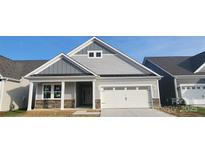 Charming single-Gathering home featuring stone accents, a covered entryway, and an attached two-car garage at 320 Basil Dr, Indian Trail, NC 28079