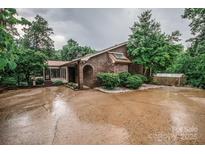 Charming brick home featuring an arched entryway, skylight, and beautiful landscaping on a wooded lot at 3700 Nw Gainesway Nw Ct, Concord, NC 28027