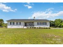 Charming single-story home with white brick exterior, black shutters, and a well-manicured lawn at 4855 Saluda Rd, Rock Hill, SC 29730