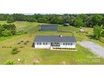 Expansive property features a white ranch home, large outbuilding, and fenced pastureland at 4855 Saluda Rd, Rock Hill, SC 29730