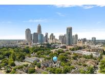 Stunning aerial view of the property with the downtown skyline in the background on a sunny day at 513 N Graham St # 1B, Charlotte, NC 28202