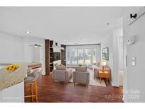 Bright living room features hardwood floors, large windows, and modern decor at 513 N Graham St # 1B, Charlotte, NC 28202