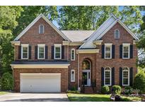 Beautiful two-story brick home with attached two-car garage and mature landscaping at 909 Staghorn Ln, Waxhaw, NC 28173