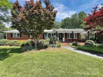 Charming brick home with lush front yard landscaping, mature trees, and inviting curb appeal at 104 Tobe Bridge Rd, Kings Mountain, NC 28086