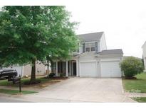 Traditional two-story home with a two car garage and a well-maintained front yard at 10901 Claude Freeman Dr, Charlotte, NC 28262