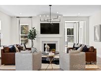 Bright living room with a modern fireplace, stylish furnishings and lots of natural light at 1099 Sugar Creek Rd, Indian Land, SC 29707