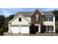 Two story home with a two car garage, brick facade, and manicured lawn at 2330 Winthorp Ridge Rd, Charlotte, NC 28270