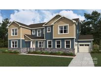 Craftsman elevation home with two-tone siding, stone accents, manicured lawn, and an attached two-car garage at 2522 Mabel Ln, Monroe, NC 28110